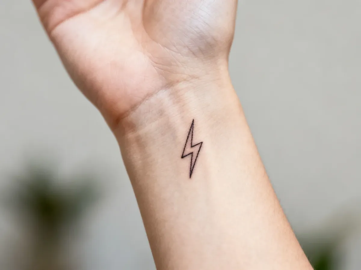 Small lightning bolt tattoo near the wrist